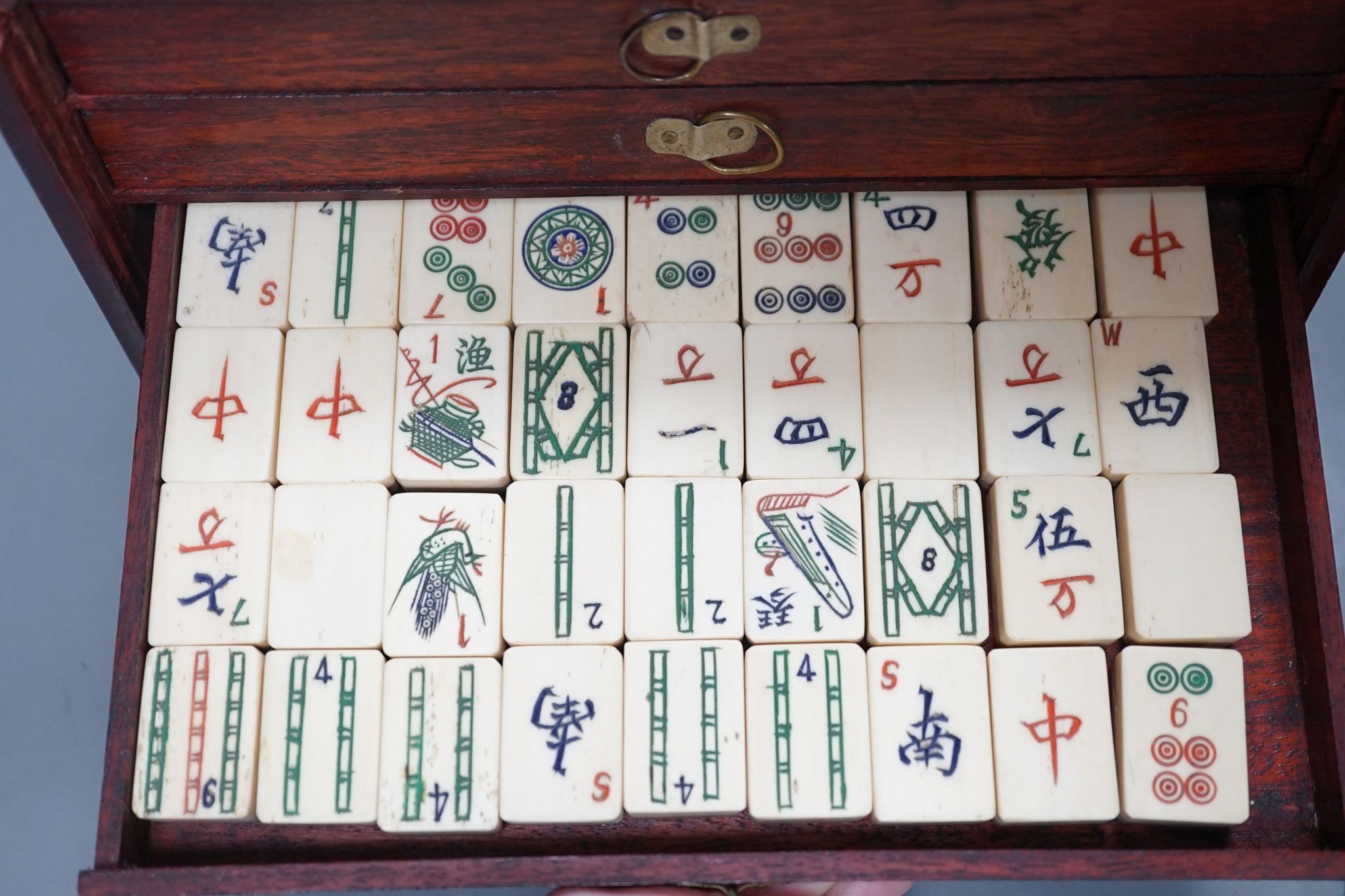 A MahJong set and a Chinese brass mounted card case., MahJong set, 15.5 cms high x 23.5 cms wide.